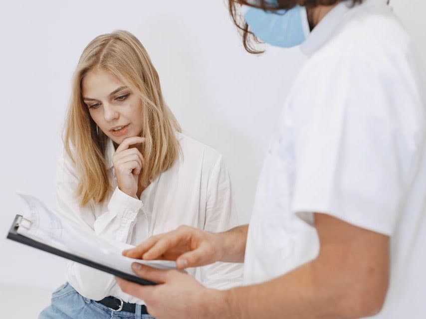 A physician talking with a patient about their health history