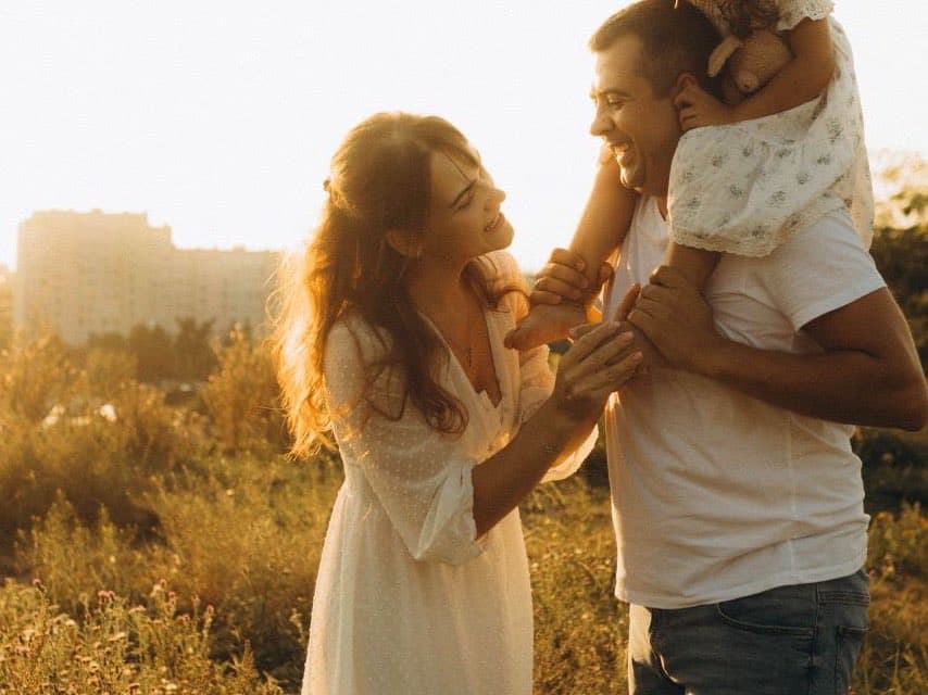 A family together outdoors at sunset